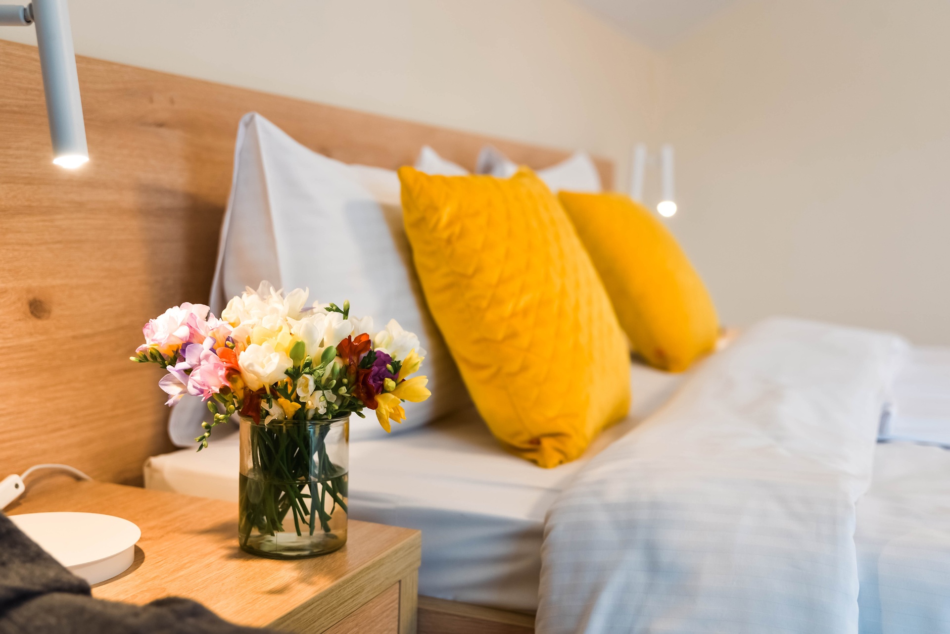 Romantyczny detal pokoju — świeże frezje przy łóżku, B&B w Wiśle